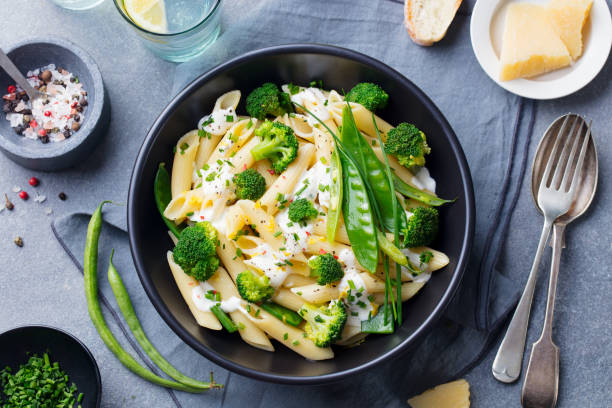 Pasta with green vegetables with parmesan cheese and fresh bas